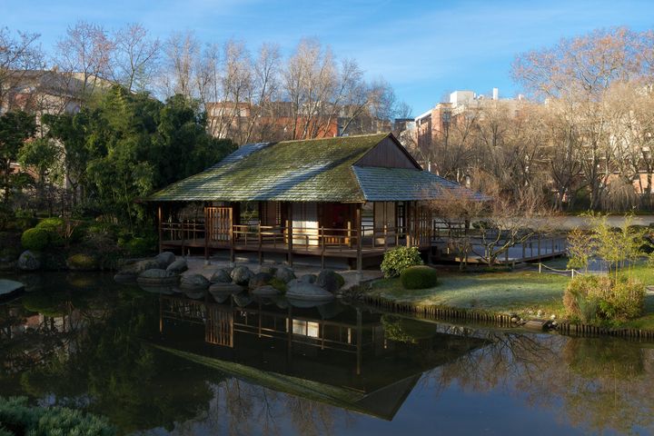 Tea house beside a pond in a Japanese garden