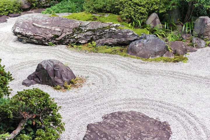 Japanese dry garden with raked gravel, rocks and moss