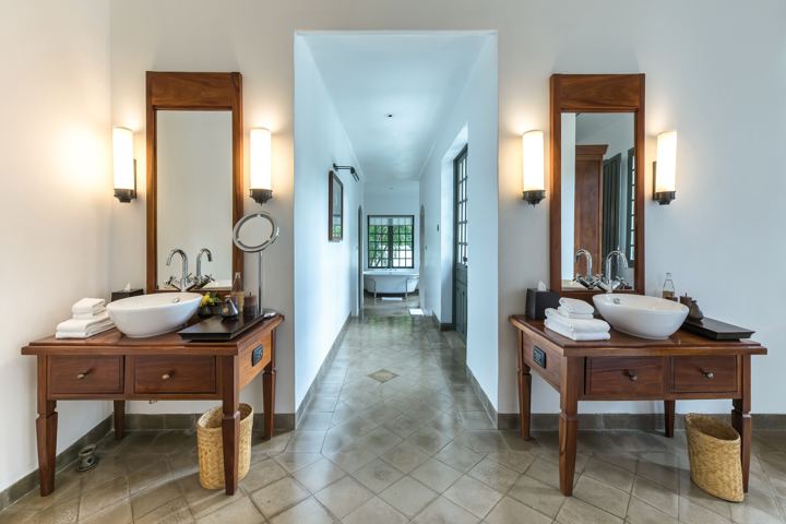 Calm bathroom with twin basins and wooden furniture
