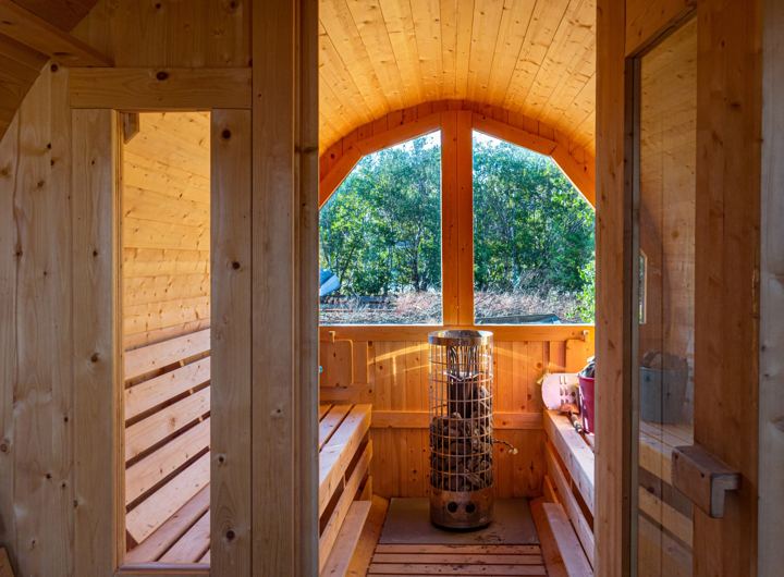 Inside a barrel sauna with a round window