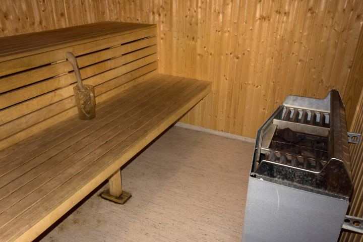 Light wooden sauna bench and heater