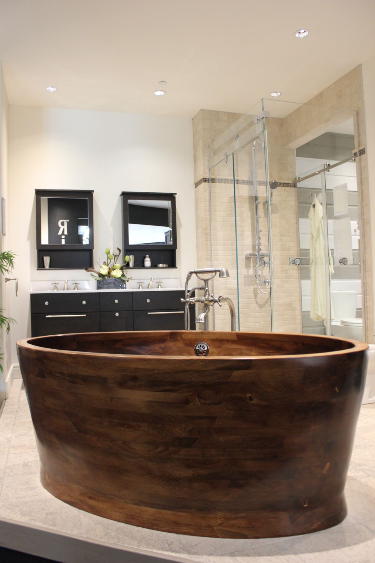 Dark wooden freestanding tub in a modern bathroom