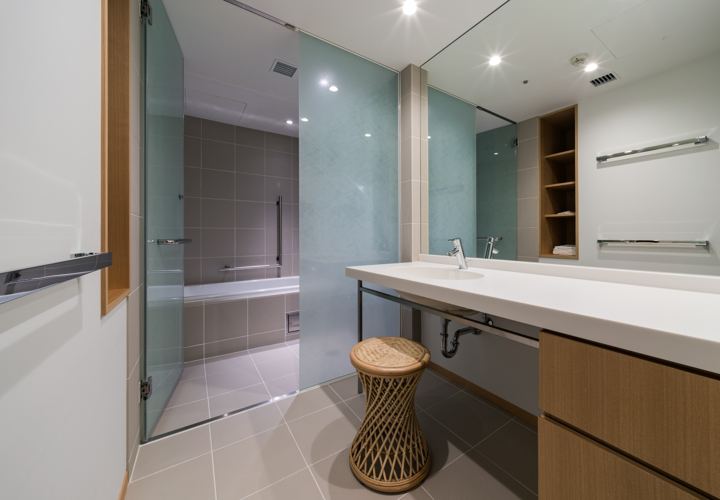 Bright washroom with vanity and wooden stool