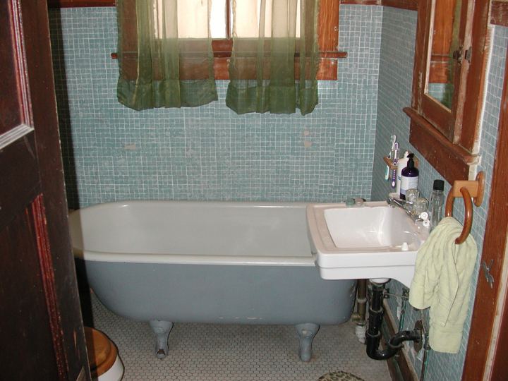 Vintage bathroom with clawfoot tub before renovation